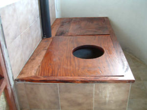 Twin chamber composting toilet. When one chamber is full, the opening is swapped.